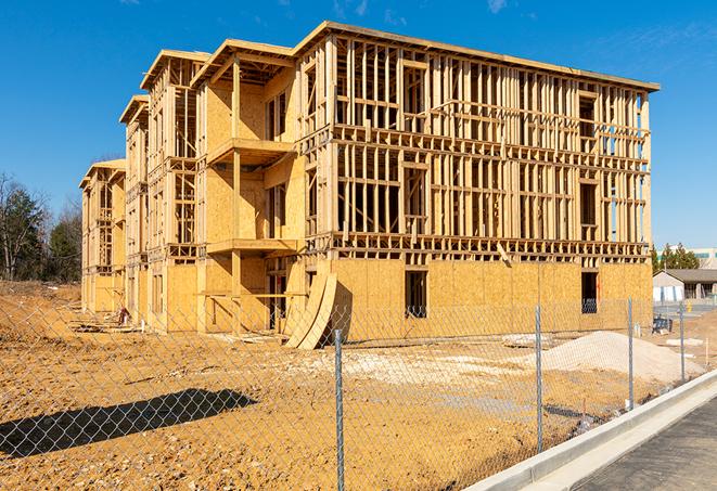 workers protected by temporary barrier fence during building maintenance in Wilberforce, OH